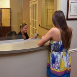 A woman being helped at reception